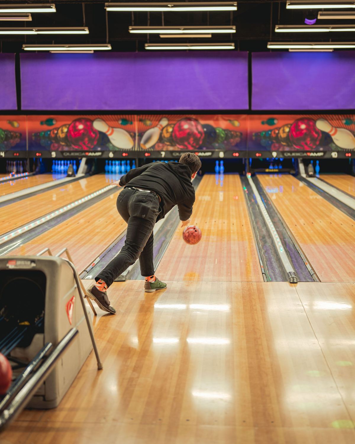 Bowler seen from behind on the approach, putting bowling tips for beginners into practice