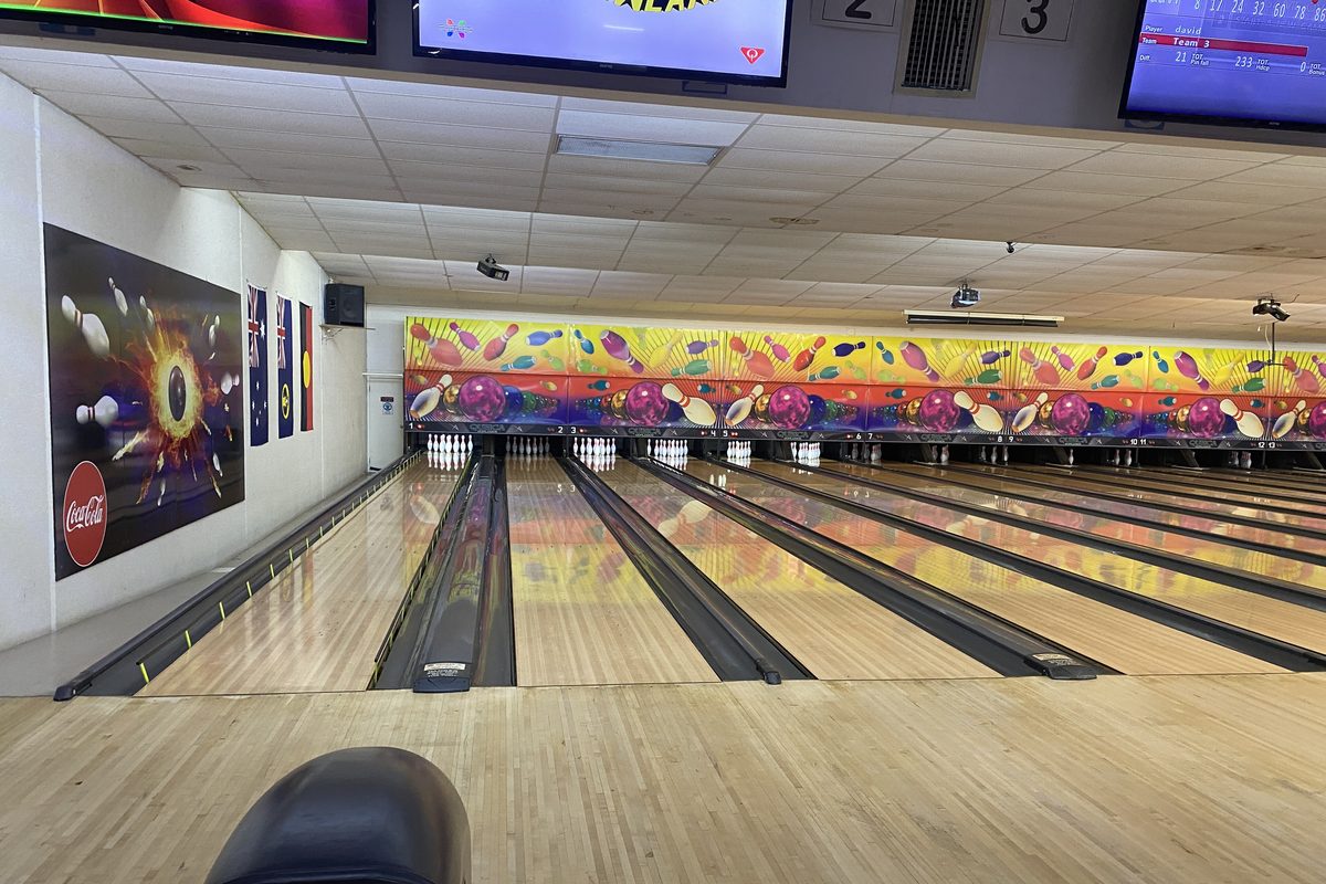 Row of polished lanes leading to the pins, where these bowling tips are put to work