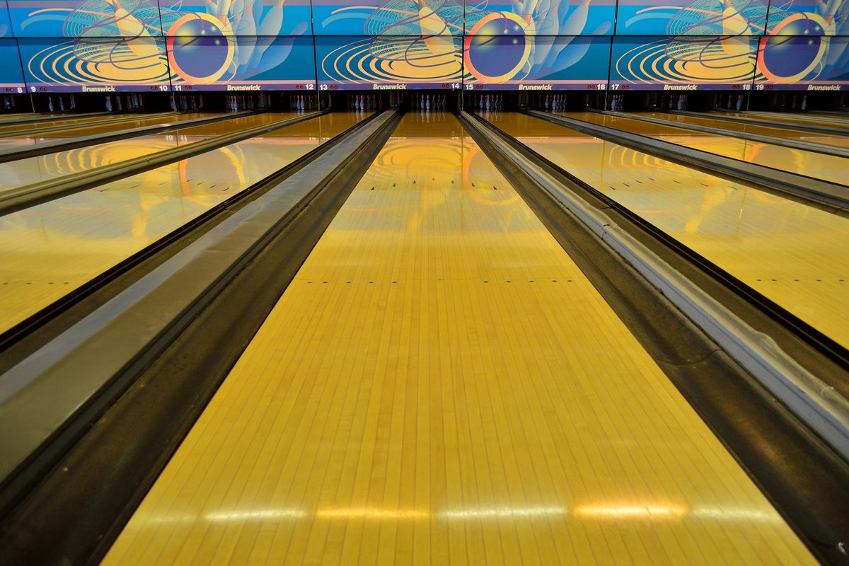 Polished wooden bowling lane seen from the approach, header photo for our privacy policy